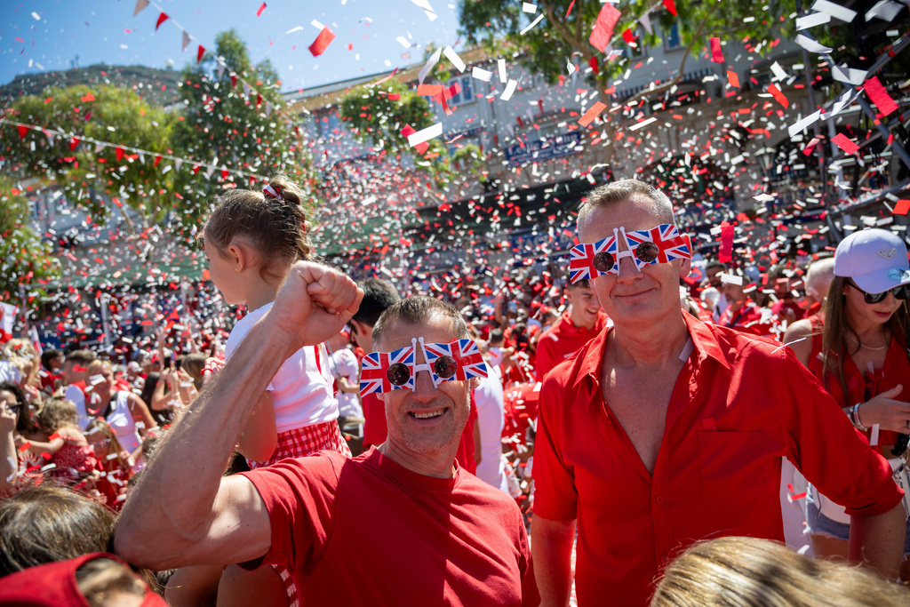 People cheer during National Day celebrations in the contested territory of Gibraltar on Wednesday Sept. 10, 2025. (AP Photo/Marcos Moreno)