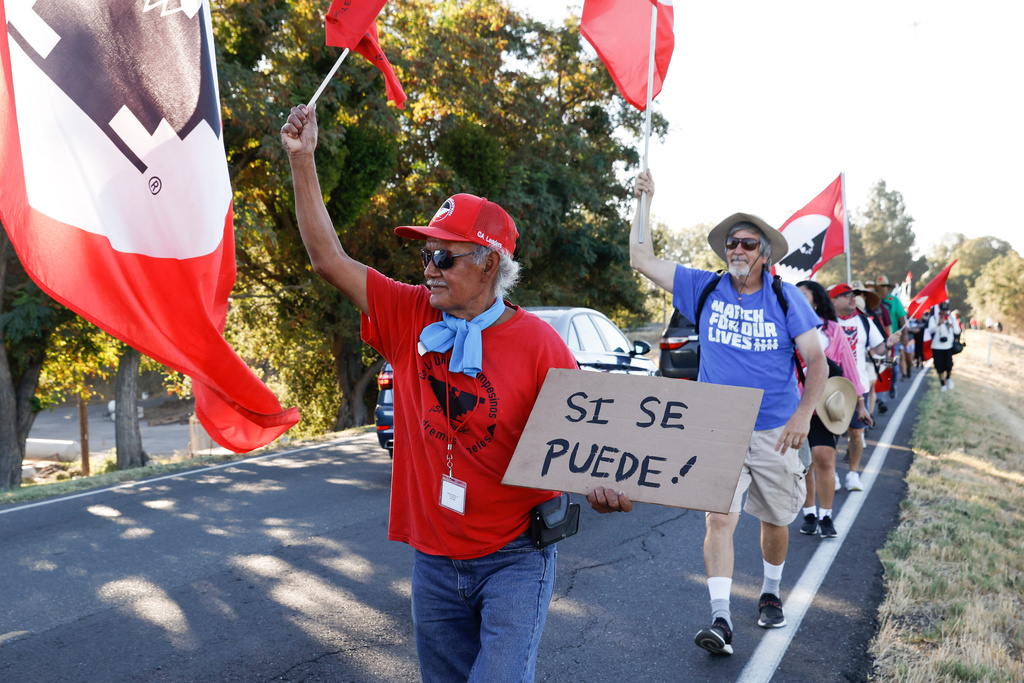 FILE - Asunción Ponce, left, marches with fellow members of the United Farm Workers in support of a bill that would allow farmworkers to vote by mail in union elections, near Walnut Grove, Calif., Wednesday, Aug. 24, 2022. (Jessica Christian /San Francisco Chronicle via AP)