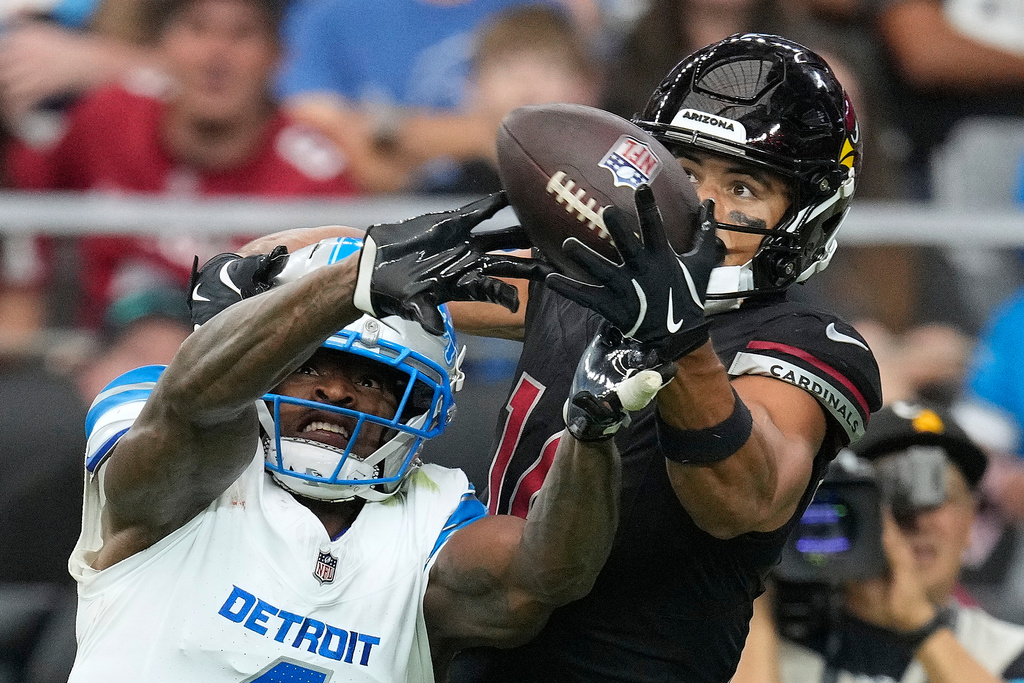 Detroit Lions cornerback D.J. Reed (4) breaks up a pass intended for Arizona Cardinals wide receiver Michael Wilson (14) during the second half of an NFL football game in Glendale, Ariz., Sunday, Oct. 11, 2026. (AP Photo/Ross D. Franklin)