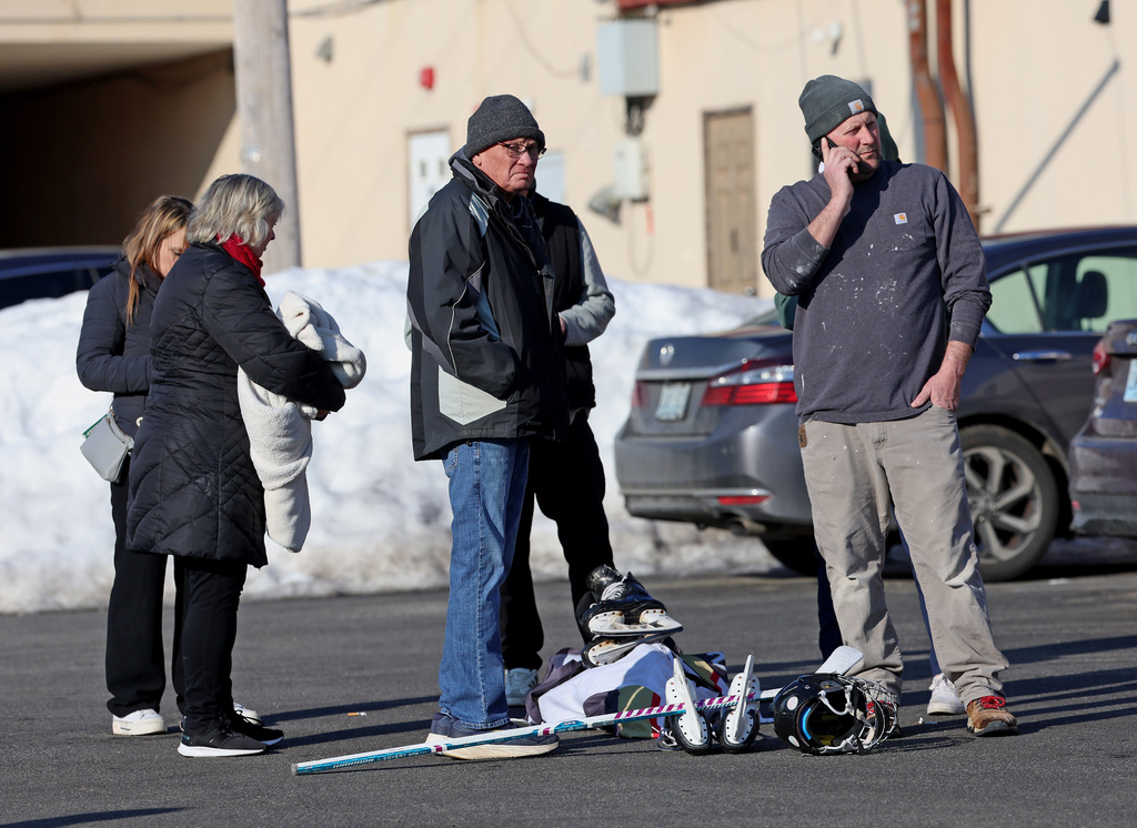 Hockey parents congregate near the Lynch Arena in Pawtucket, R.I., after a shooting at the ice rink, Monday, Feb. 16, 2026. (AP Photo/Mark Stockwell)