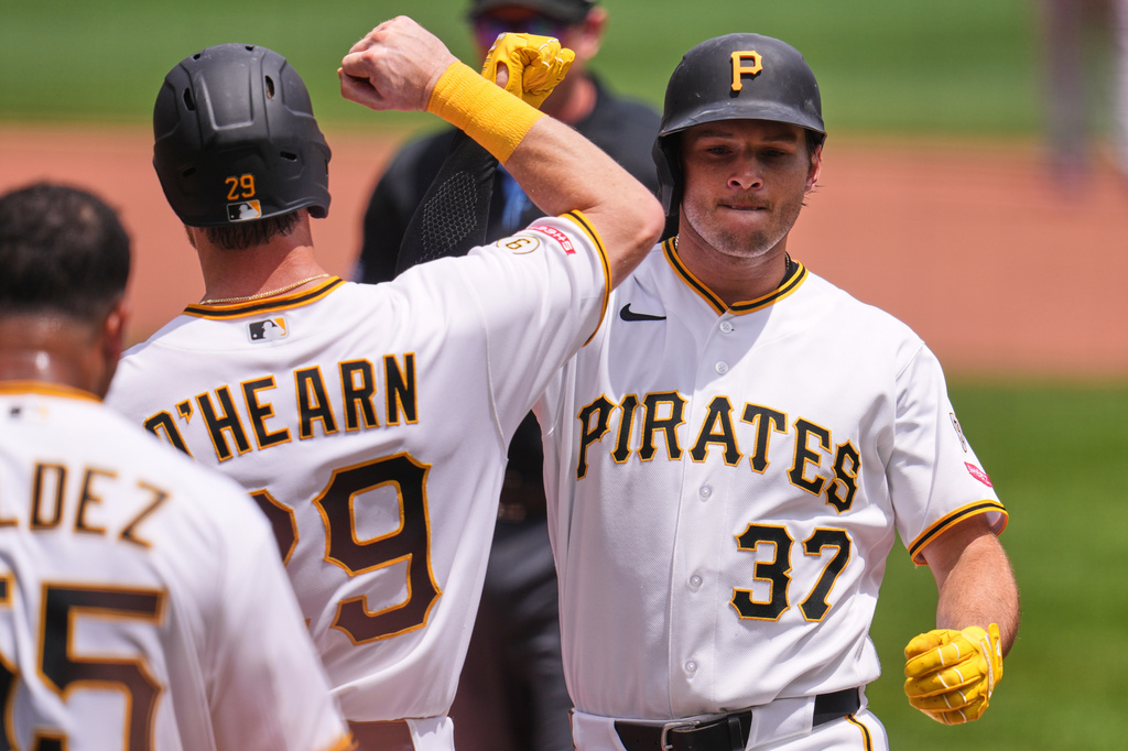 Pittsburgh Pirates' Tyler Callihan (37) celebrates with Ryan O'Hearn (29) as he crosses home plate after hitting a three-run home run off Cincinnati Reds pitcher Brady Singer during the second inning of a baseball game in Pittsburgh, Sunday, June 28, 2026. (AP Photo/Gene J. Puskar)