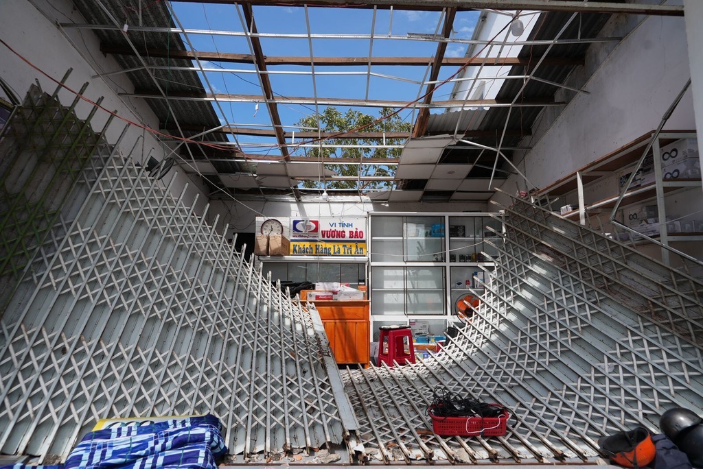 A damaged roof and an entrance in Dak Lak, Vietnam on Friday, Nov. 7, 2025 after Typhoon Kalmaegi lashed Vietnam with fierce winds and torrential rains. (AP Photo/Hau Dinh)