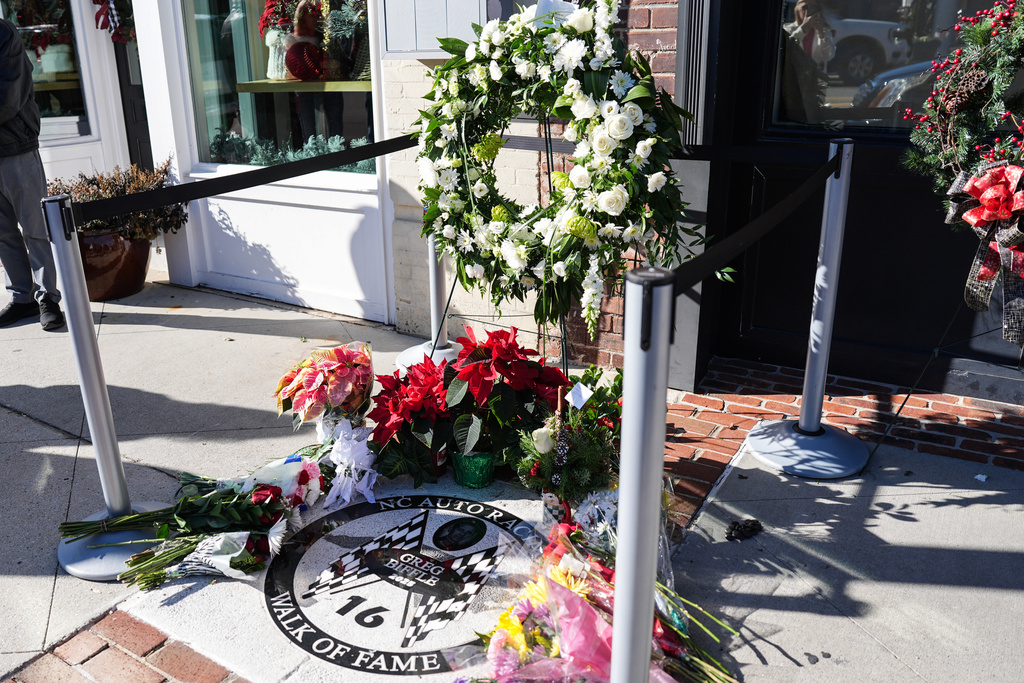 Flowers are displayed at the NC Auto Racing Walk of Fame for Greg Biffle, Friday, Dec. 19, 2025, in Mooresville, N.C. (AP Photo/Matt Kelley)