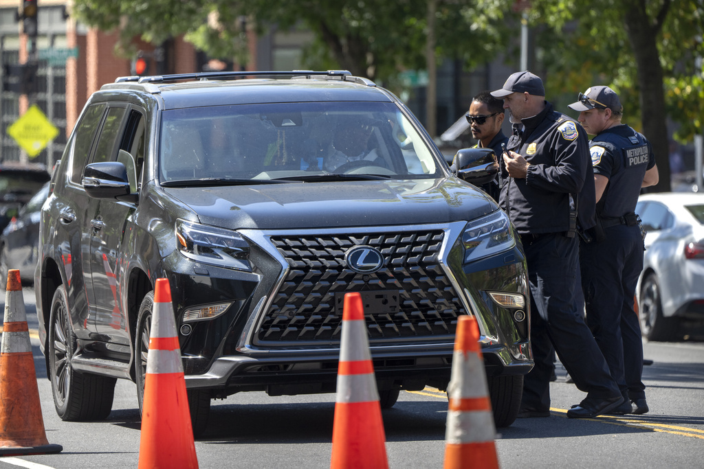 Metropolitan Police Department officers talk to a driver at a checkpoint operated by the Metropolitan Police Department and federal agencies, including officers from Immigration and Customs Enforcement (ICE) and Homeland Security Investigations (HSI), on Georgia Avenue in the northern part of Washington, Saturday, Aug. 30, 2025. (AP Photo/Mark Schiefelbein)