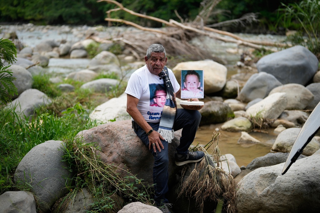 Benjamin Herrera shows a photo of his son Oscar Fernando Herrera, who disappeared during the avalanche triggered by the Nevado del Ruiz volcanic eruption that killed about 25,000 people in Armero, Colombia, Wednesday, Nov. 12, 2025, the day before the 40 year anniversary of the eruption. (AP Photo/Fernando Vergara)