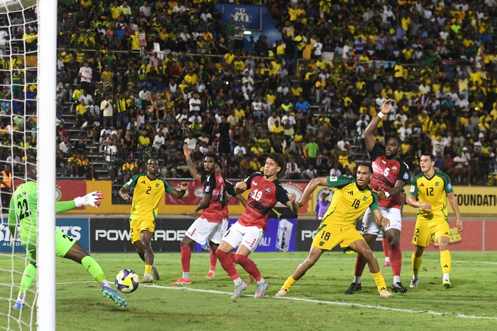 Jamaica's Jonathan Russell, third from right, scores his side's second goal against Trinidad and Tobago during a World Cup 2026 qualifying soccer match at the Independence Park stadium in Kingston, Jamaica, Tuesday, Sept. 9, 2025. (AP Photo/Collin Reid)