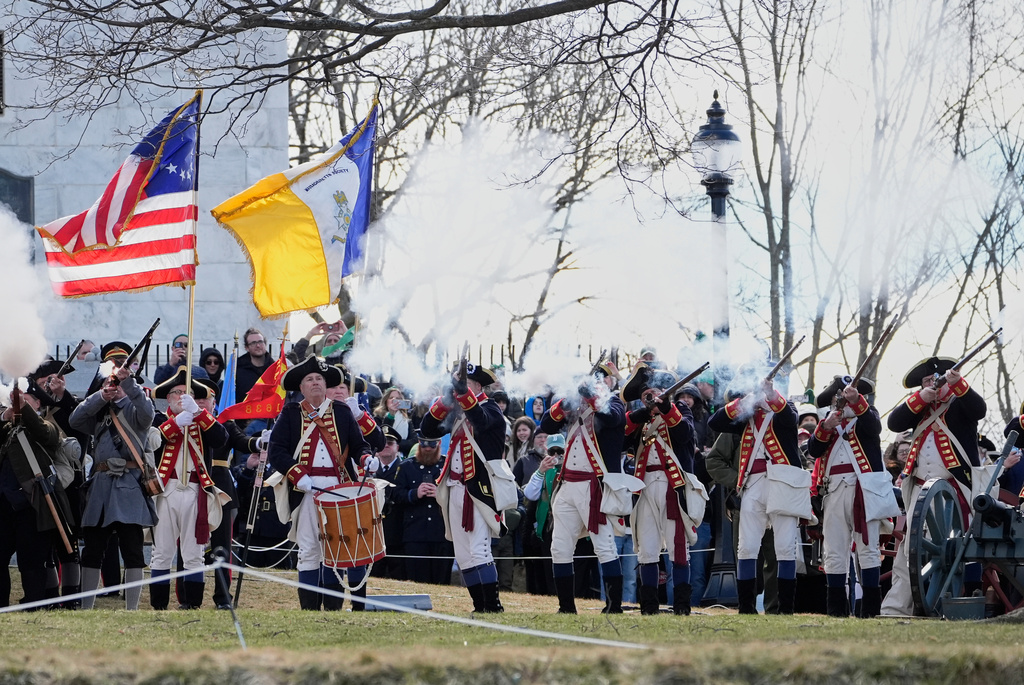 Reenactors fire muskets during an Evacuation Day ceremony marking the 1776 departure of British troops from the city during the American Revolutionary War, Tuesday, March 17, 2026, in Boston. (AP Photo/Robert F. Bukaty)