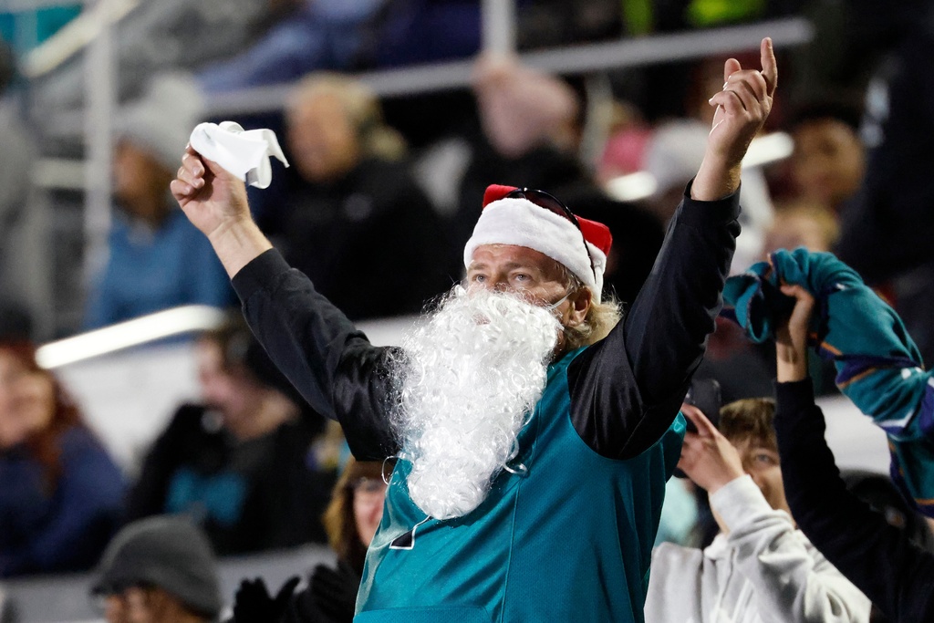 A Coastal Carolina fan wears a Santa Claus beard and hat during the second half of an NCAA college football game against James Madison in Conway, S.C., Saturday, Nov. 29, 2025. (AP Photo/Nell Redmond)