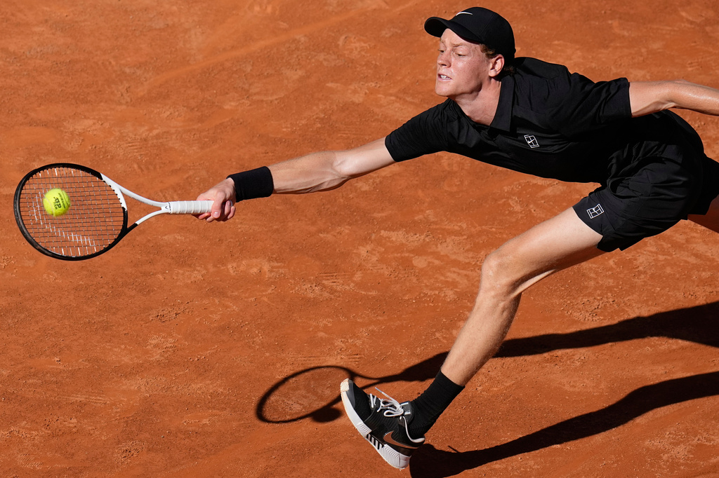 Italy's Jannik Sinner stretches to return the ball to Australia's Alexei Popyrin, during their match at the Italian Open tennis tournament in Rome, Monday, May 11, 2026. (AP Photo/Alessandra Tarantino)