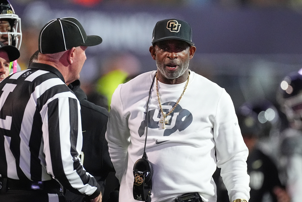 Colorado head coach Deion Sanders confers with referee in the first half of an NCAA college football game against Utah Saturday, Oct. 17 2026, in Boulder, Colo. (AP Photo/David Zalubowski)