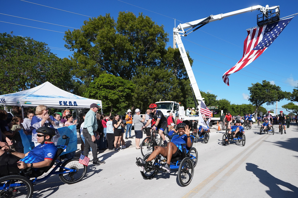Wounded veterans ride past a crowd gathered at Coral Shores High School in the annual Florida Keys Soldier Ride organized by the Wounded Warrior Project, Friday, Jan. 9, 2026, in Islamorada, Fla. (AP Photo/Lynne Sladky)