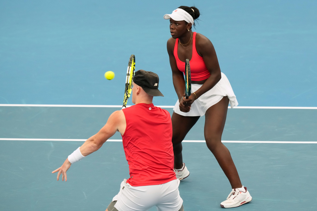 Victoria Mboko,right, and Cleeve Harper of Canada compete against Elise Mertens and Zizou Bergs of Belgium in their doubles match at the United Cup tennis tournament in Sydney, Tuesday, Jan. 6, 2026. (AP Photo/Rick Rycroft)