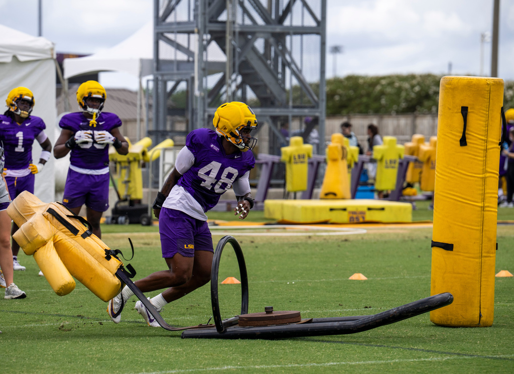 LSU defensive end Kolaj Cobbins (48) races to a blocking dummy during drills at an NCAA college football practice Monday, Aug. 10, 2026, in Baton Rouge, La. (Michael Johnson/The Advocate via AP)