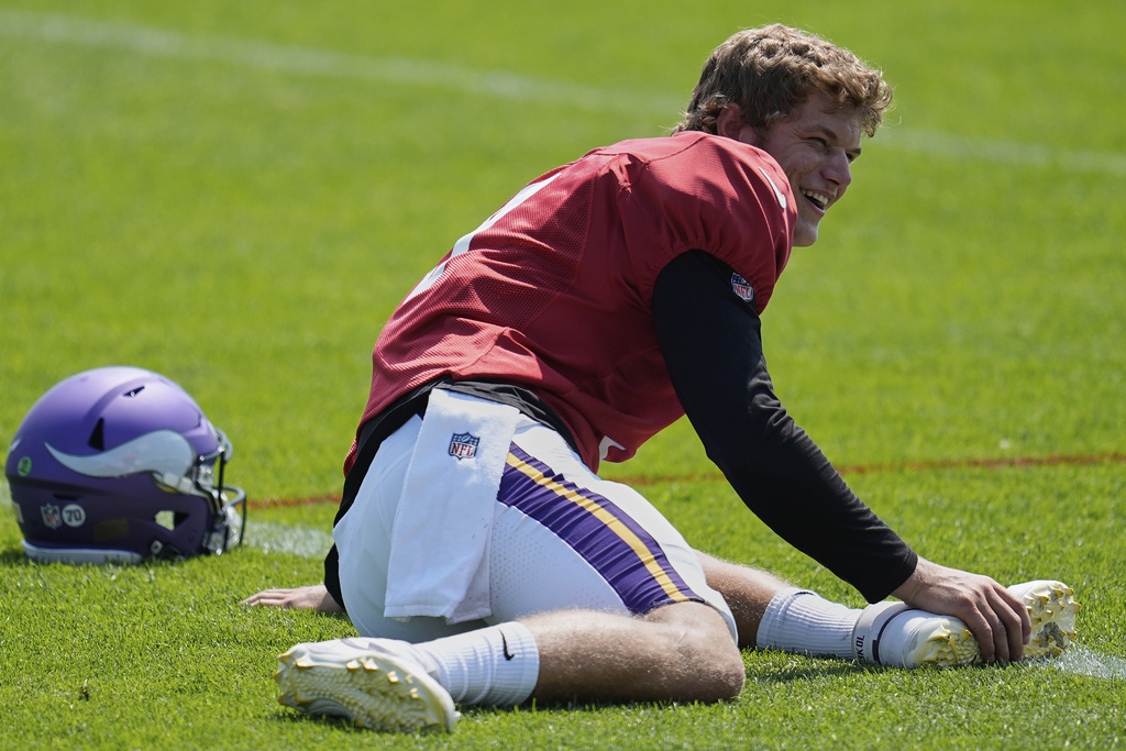 Minnesota Vikings quarterback J.J. McCarthy (9) stretches during a joint NFL football training camp with the New England Patriots, Wednesday, Aug. 13, 2025, in Eagan, Minn. (AP Photo/Abbie Parr)