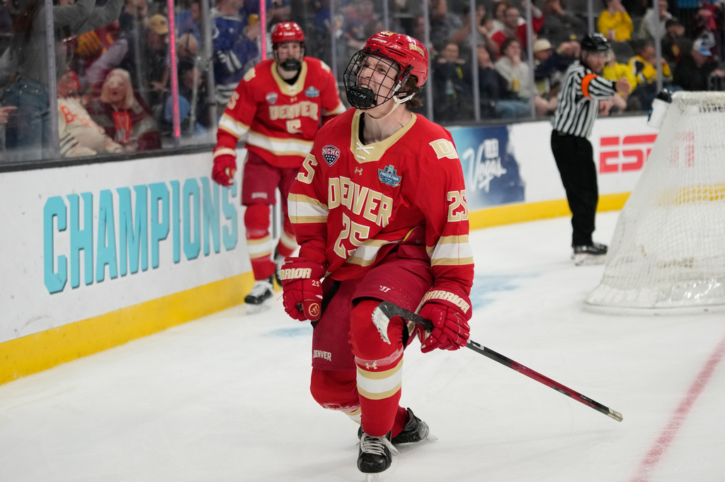 Denver forward Clarke Caswell (25) celebrates after scoring against Michigan in the third period of a semifinal game of the NCAA Frozen Four men's college hockey tournament Thursday, April 9, 2026, in Las Vegas. (AP Photo/John Locher)