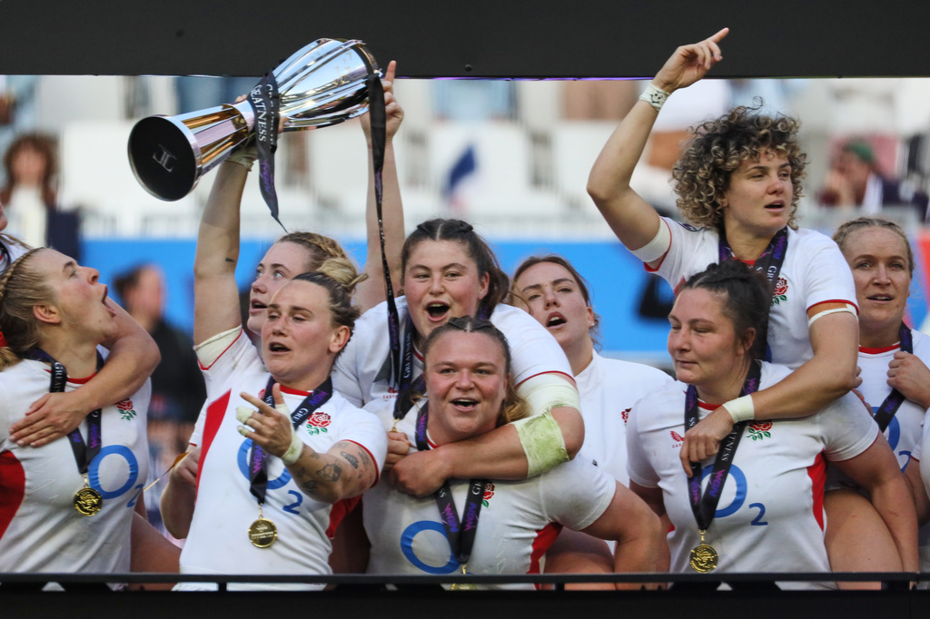 England's captain Megan Jones holds the trophy after aloft after her team won the Six Nations rugby union match between France and England in Bordeaux, Sunday, May 17, 2026. (AP Photo/Yohan Bonnet)