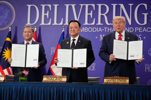 President Donald Trump, Cambodian Prime Minister Hun Manet, left, and Thailand's Prime Minister Anutin Charnvirakul pose with their documents during a signing ceremony on the sidelines of the ASEAN Summit in Kuala Lumpur, Malaysia, Sunday, Oct. 26, 2025. (AP Photo/Mark Schiefelbein) President Donald Trump, Cambodian Prime Minister Hun Manet, left, and Thailand's Prime Minister Anutin Charnvirakul pose with their documents during a signing ceremony on the sidelines of the ASEAN Summit in Kuala Lumpur, Malaysia, Sunday, Oct. 26, 2025. (AP Photo/Mark Schiefelbein)