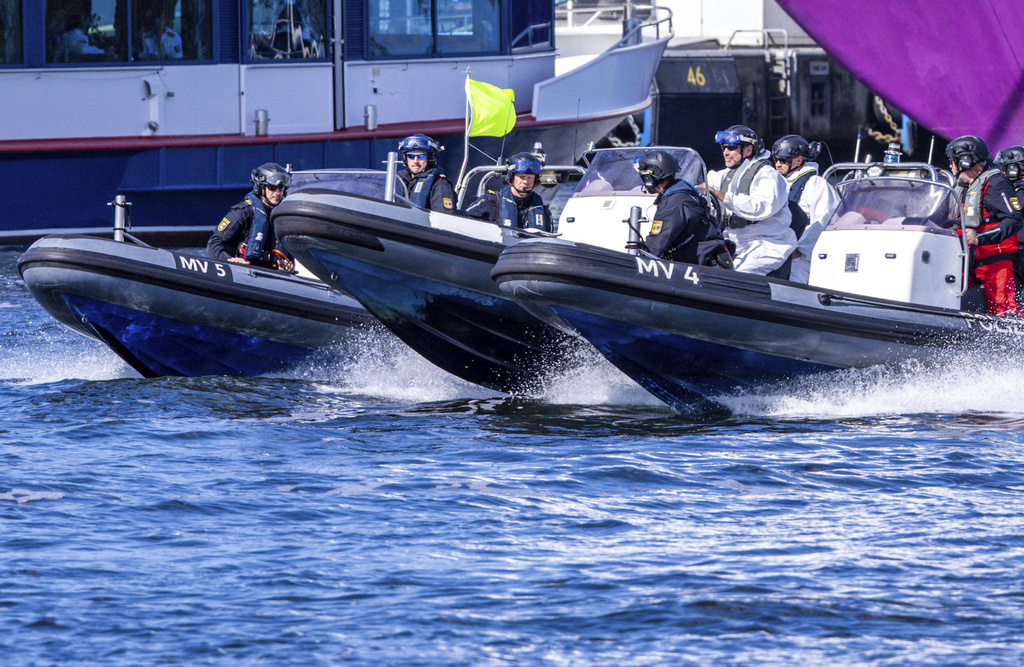 Special police units arrest an assumed attacker on a rubber dinghy at the start of Media Day as part of the 'Quadriga 2025' military maneuver in Rostock, Germany, Thursday, Sept. 4, 2025. (Jens Buettner/dpa via AP)