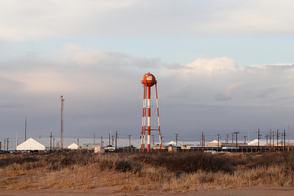 A series of hardened tents at the Camp East Montana immigrant detention center loom large in the desert at a U.S. Army base on the outskirts of El Paso, Texas, Friday, Feb. 13, 2026. (AP Photo/Morgan Lee)