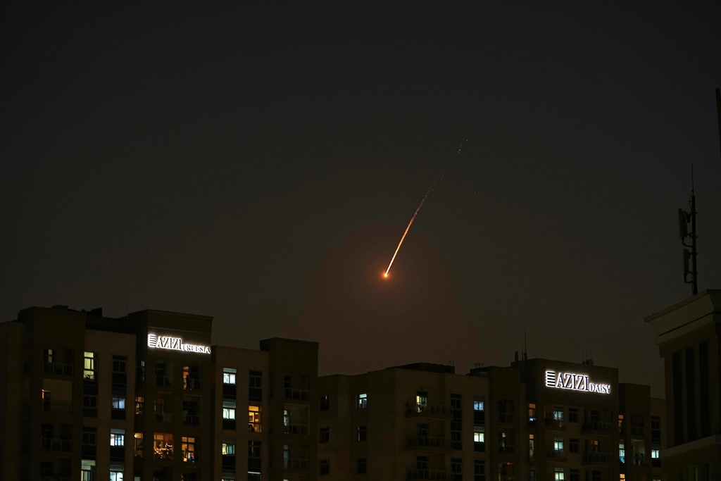 The flare of a projectile is seen over the skyline of Dubai, United Arab Emirates, Saturday, Feb. 28, 2026. (AP Photo/Fatima Shbair)