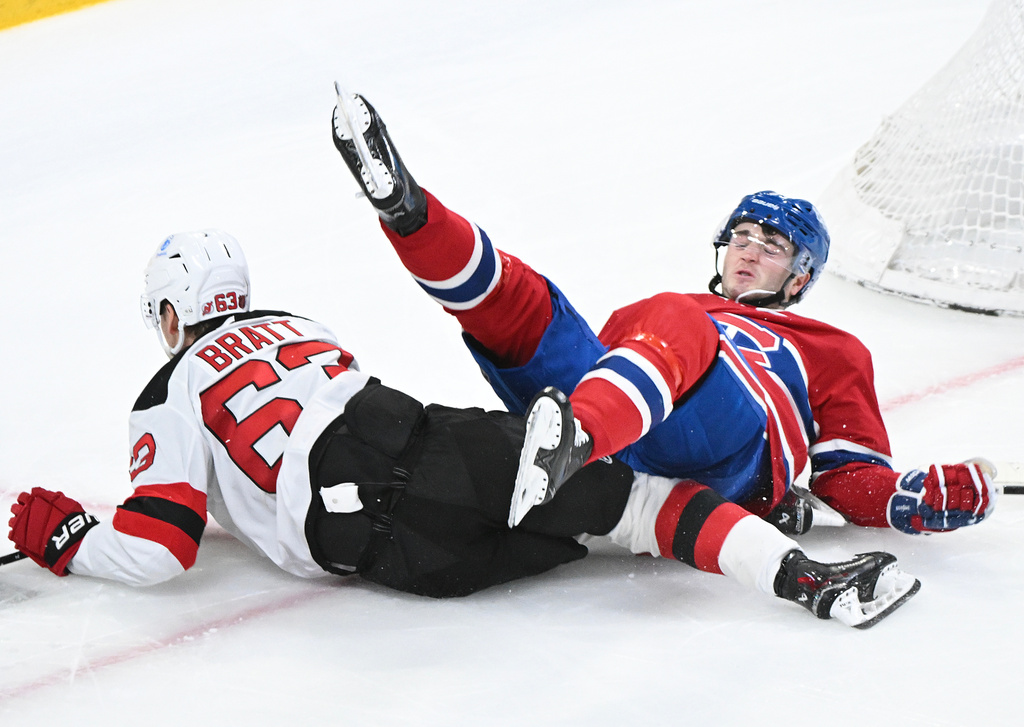 New Jersey Devils' Jesper Bratt (63) collides with Montreal Canadiens' Noah Dobson during the second period of an NHL hockey game in Montreal, Sunday, April 5, 2026. (Graham Hughes/The Canadian Press via AP)