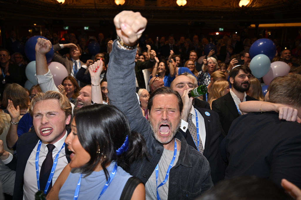 Liberal Party members react to the presentation of the exit poll at the election night watch party, in Stockholm, Sunday, Sept. 13, 2026. (Anders Wiklund/TT News Agency via AP)