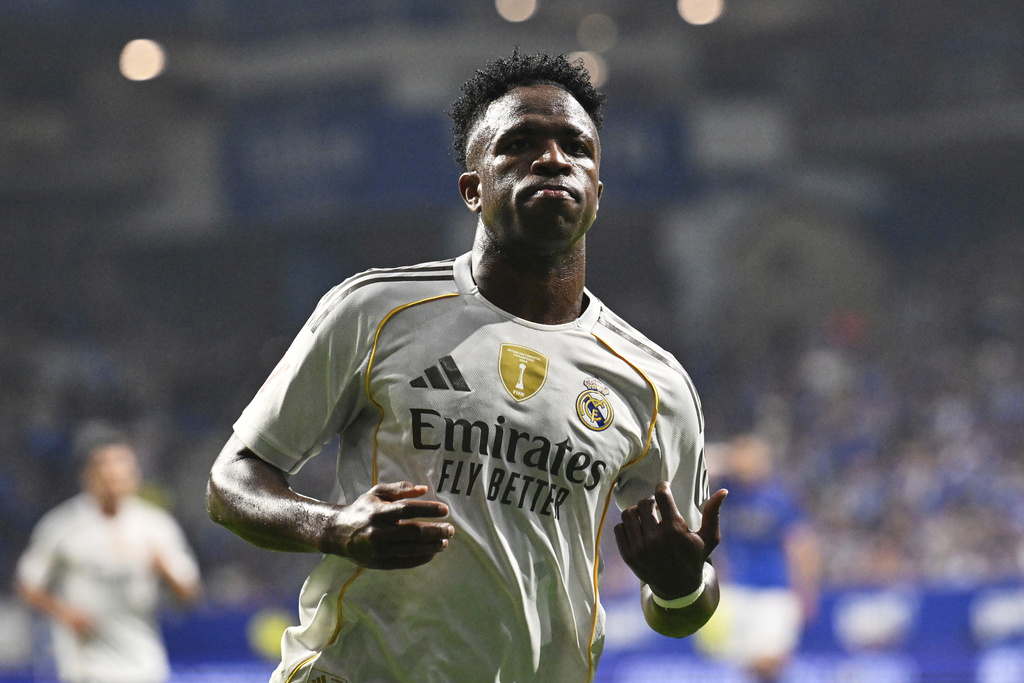 Real Madrid's Vinicius Junior celebrates after assisting teammate Kylian Mbappe to score during a Spanish La Liga soccer match between Real Oviedo and Real Madrid at Carlos Tartiere stadium in Oviedo, Spain, Sunday, Aug. 24, 2025. (AP Photo/Miguel Oses)