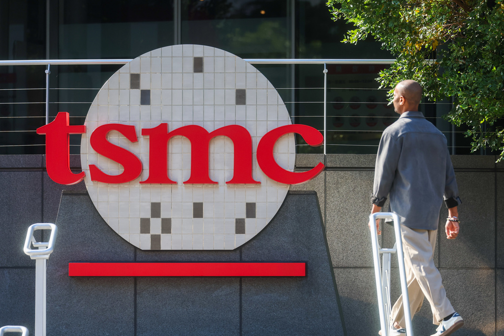 FILE - A worker walks past the logo of TSMC or Taiwan Semiconductor Manufacturing Corp., a Taiwanese multinational semiconductor contract manufacturing and design company, in Hsinchu, Taiwan, on Jan. 29, 2026. (AP Photo/Daniel Ceng, File)