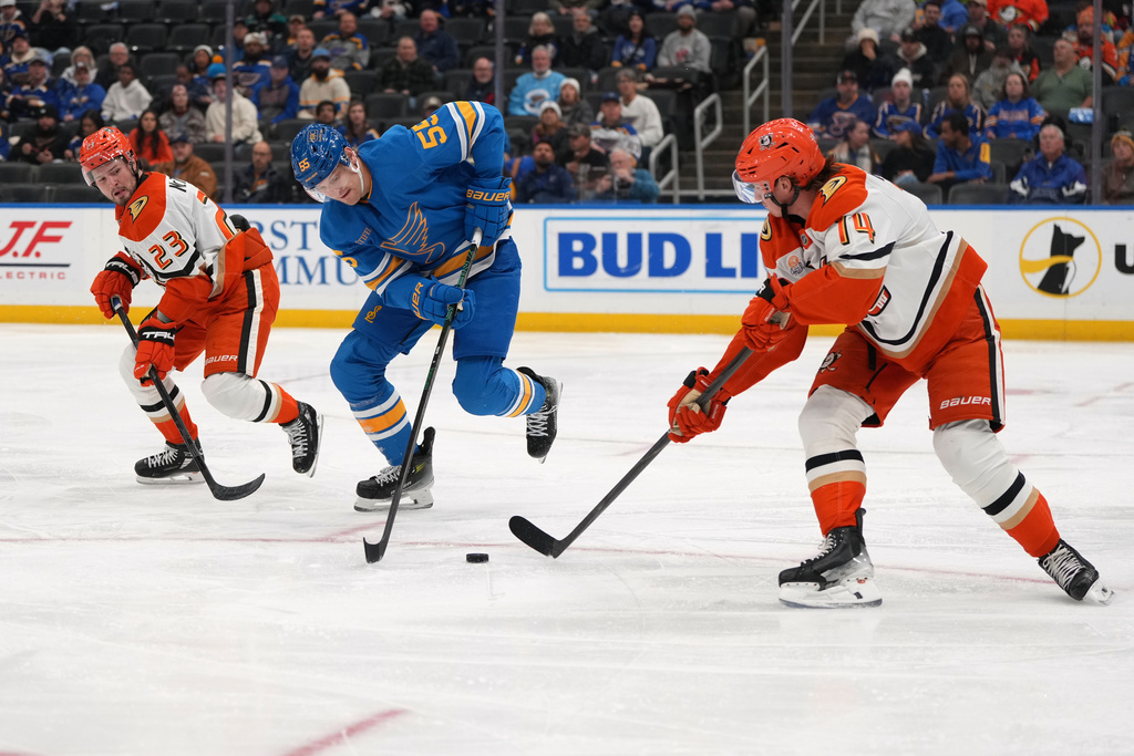 St. Louis Blues' Colton Parayko (55) chases after a loose puck between Anaheim Ducks' Mason McTavish (23) and Drew Helleson (14) during the second period of an NHL hockey game Monday, Dec. 1, 2025, in St. Louis. (AP Photo/Jeff Roberson)
