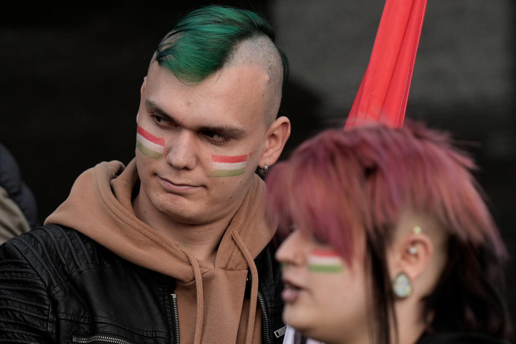 Supporters of Peter Magyar, the leader of the opposition Tisza party wait for the results of the parliamentary elections in Budapest, Hungary, Sunday, April 12, 2026. (AP Photo/Darko Bandic)