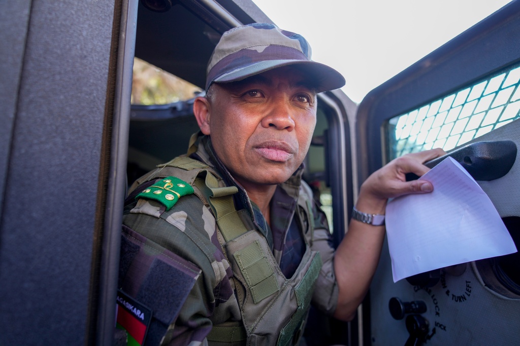 CAPSAT military unit commander Col. Michael Randrianirina and his troops make their way to the Presidency to announce that the armed forces are taking control of the country in Antananarivo, Madagascar, Tuesday, Oct. 14, 2025. (AP Photo/Brian Inganga)