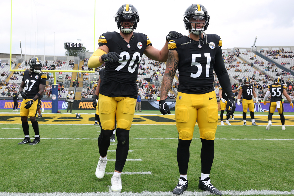 Pittsburgh Steelers outside linebacker TJ. Watt (90), left, and Pittsburgh Steelers linebacker Nick Herbig (51) stretch during warm up ahead of the NFL football game between Minnesota Vikings and Pittsburgh Steelers at Croke Park stadium in Dublin, Sunday, Sept. 28, 2025.(AP Photo/Ian Walton)