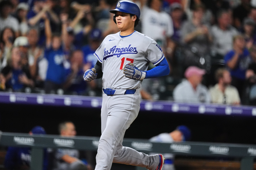Los Angeles Dodgers' Shohei Ohtani scores on a double hit by Freddie Freeman off Colorado Rockies relief pitcher TJ Shook in the eighth inning of a baseball game Monday, Aug. 17, 2026, in Denver. (AP Photo/David Zalubowski)