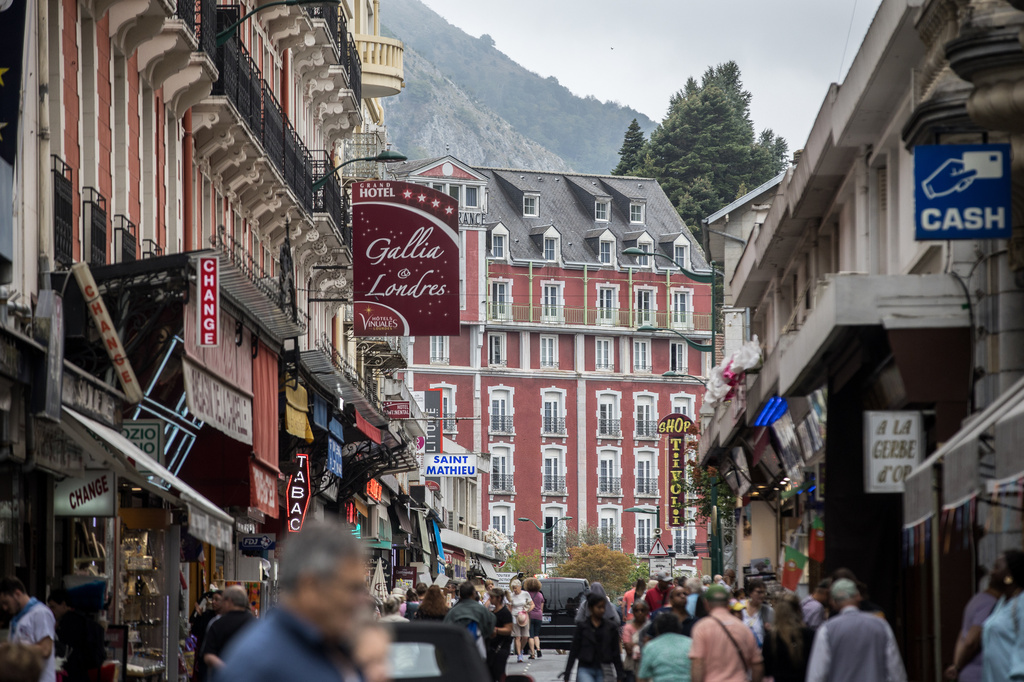 Tourists walk in the streets of Lourdes, southwestern France, Tuesday Sept. 8, 2026. (AP Photo/Fred Scheiber)