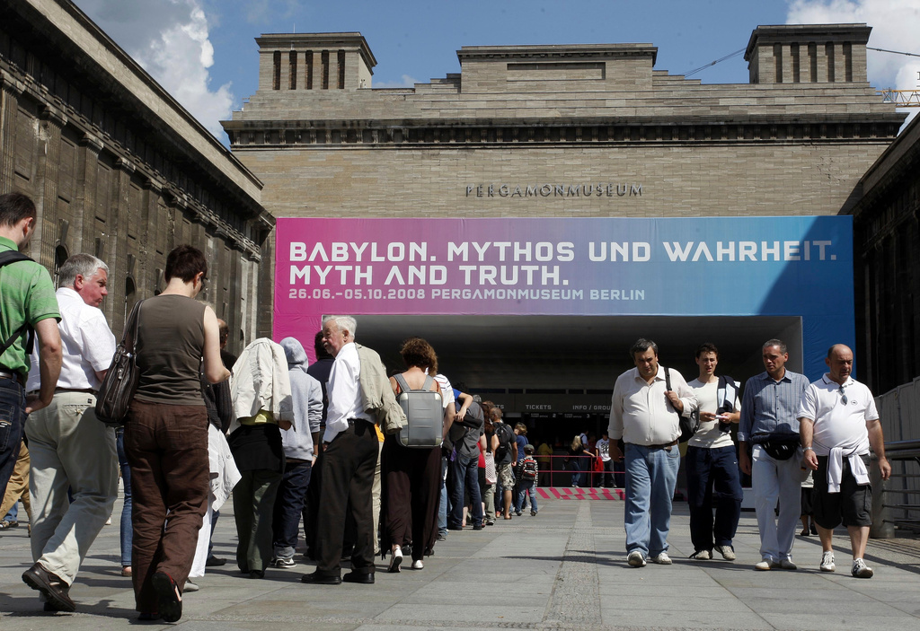 FILE - People wait in line in front of the Pergamon museum to see the exhibit "Babylon. Myth and Truth" in Berlin, Aug. 17, 2008. (AP Photo/Franka Bruns, File)