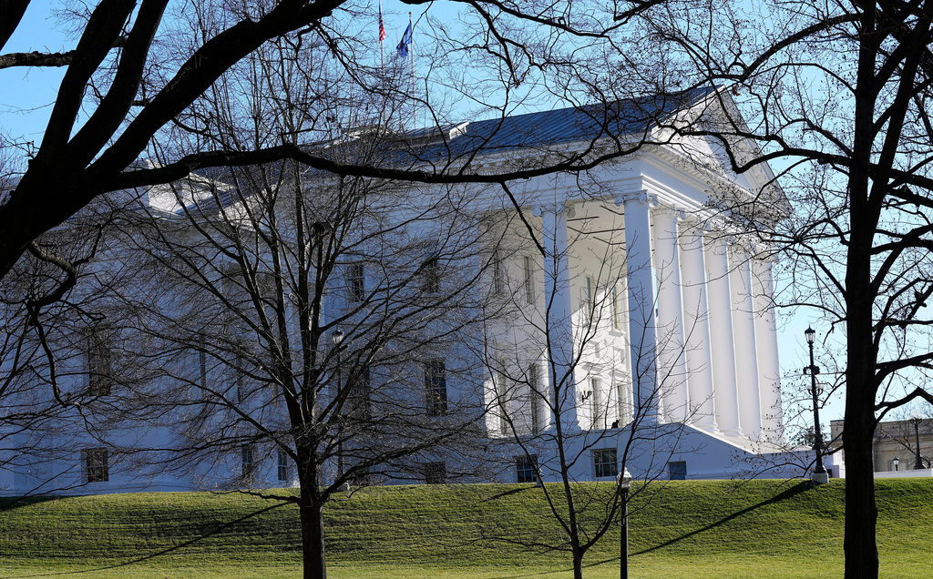 FILE - The state and U.S. flags fly over the Virginia State Capitol as the 2024 session of the Virginia General Assembly gets underway, Jan. 10, 2024, in Richmond, Va. (AP Photo/Steve Helber, File)