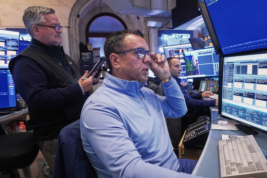Trader Robert Finnerty Jr., right, works on the floor of the New York Stock Exchange, Monday, Nov. 24, 2025. (AP Photo/Richard Drew)