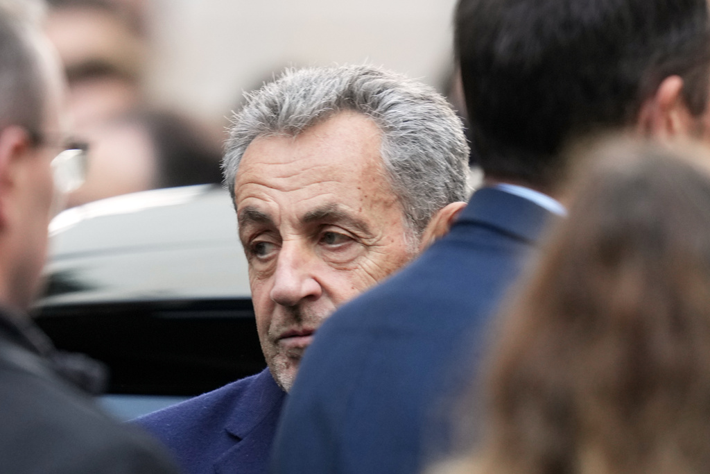 Former French President Nicolas Sarkozy reacts before entering a police car Tuesday, Oct. 21, 2025 in Paris as he heads to prison to serve time for a criminal conspiracy to finance his 2007 election campaign with funds from Libya. (AP Photo/Thibault Camus)