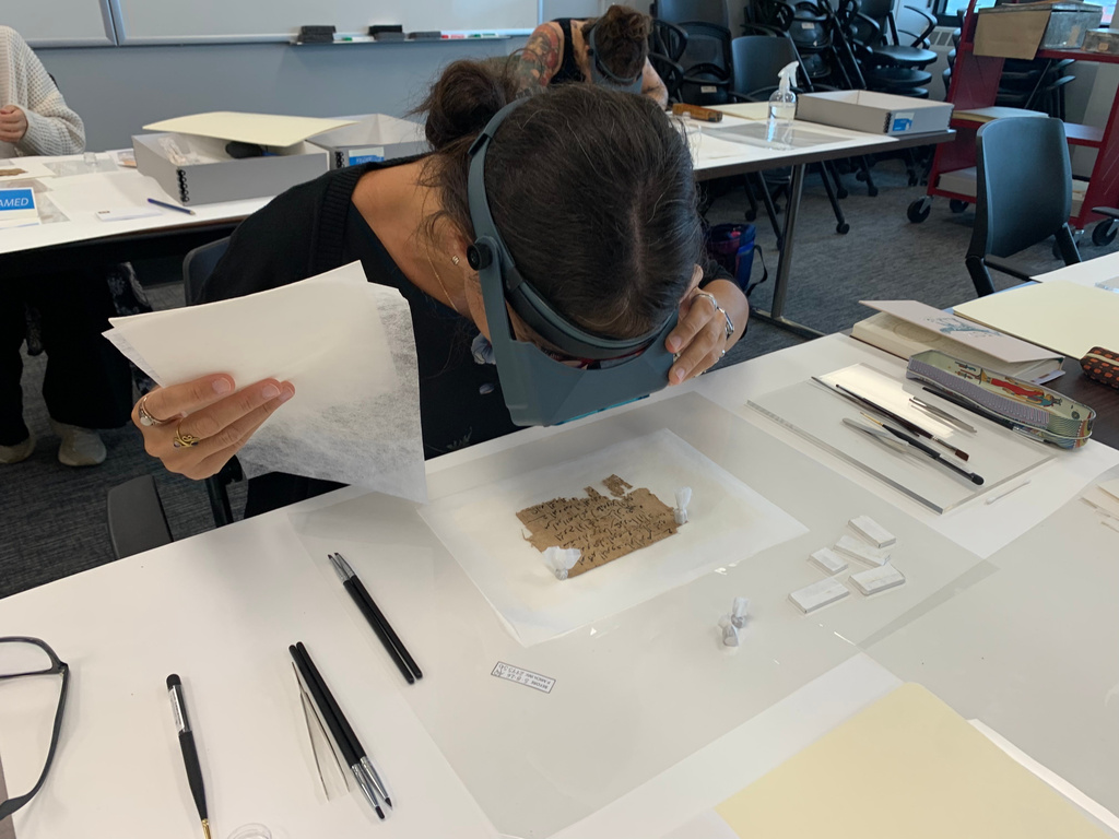Papyrus Conservation Summer Seminar student Alessandra Quadrelli examines a papyrus fragment at the University of Michigan Thursday, Aug. 6, 2026, in Ann Arbor, Mich. (AP Photo/Mike Householder)