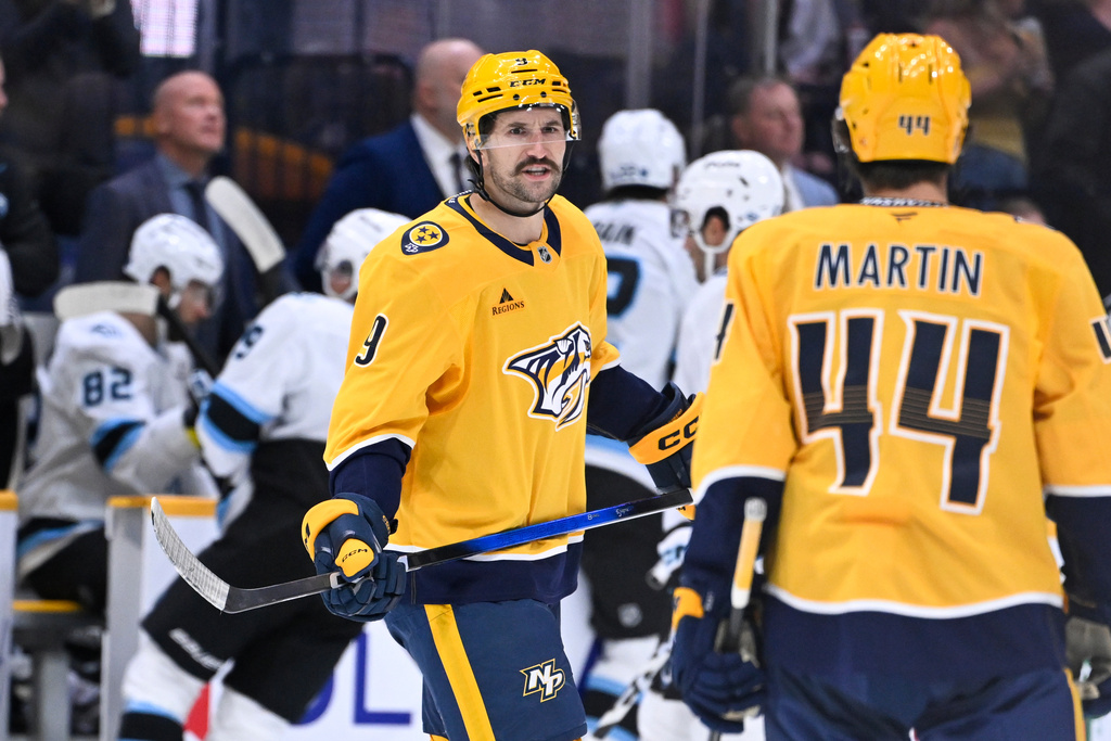 Nashville Predators left wing Filip Forsberg (9) talks to center Brady Martin (44) after scoring against the Nashville Predators during the first period of an NHL hockey game Saturday Oct. 11, 2025, in Nashville, Tenn. (AP Photo/John Amis)