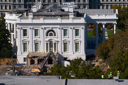 Construction workers atop the U.S. Treasury, bottom right, watch as work continues on a largely demolished part of the East Wing of the White House, Thursday, Oct. 23, 2025, in Washington, before construction of a new ballroom. (AP Photo/Jacquelyn Martin) Construction workers atop the U.S. Treasury, bottom right, watch as work continues on a largely demolished part of the East Wing of the White House, Thursday, Oct. 23, 2025, in Washington, before construction of a new ballroom. (AP Photo/Jacquelyn Martin)