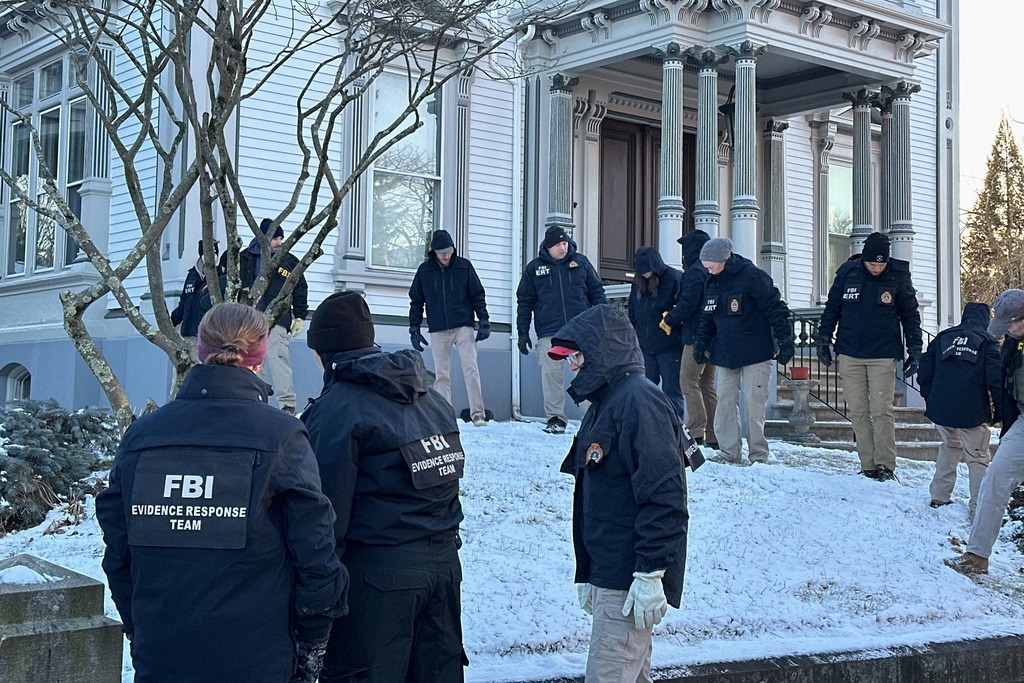 FBI officials search an area of Providence, R.I., Monday, Dec. 15, 2025. (AP Photo/Leah Willingham)