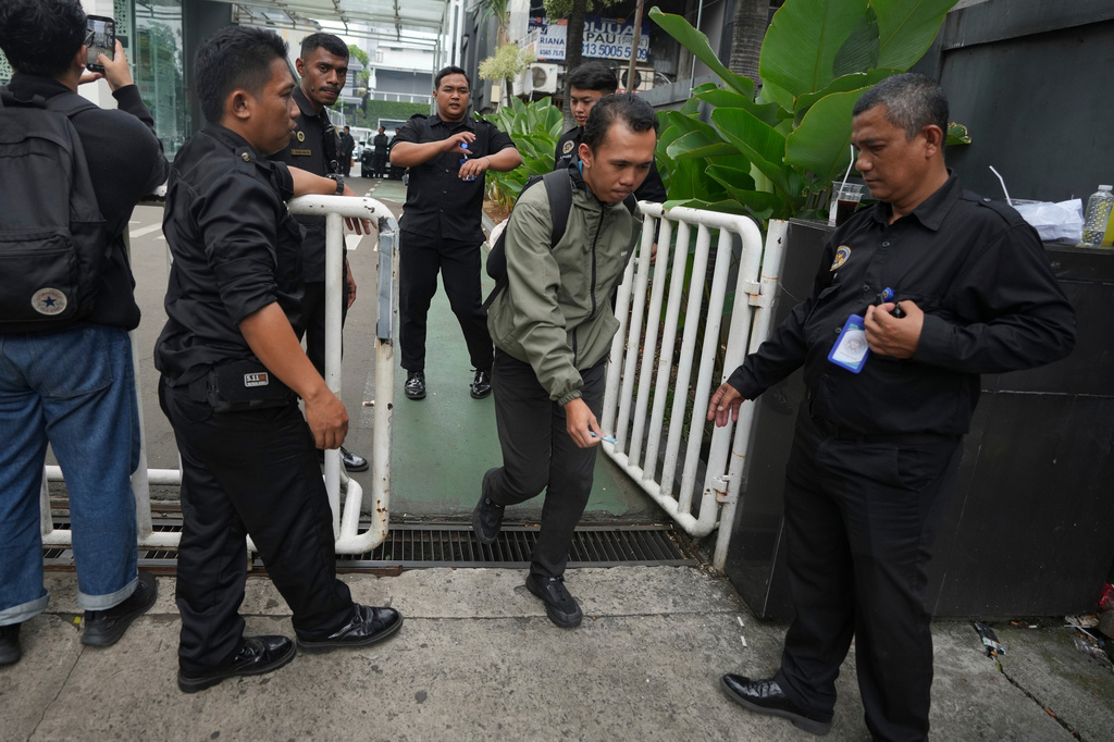 An employee leaves the office of the National Nutrition Agency as it is being searched by prosecutors, in Jakarta, Indonesia, Wednesday, June 3, 2026. (AP Photo/Dita Alangkara)