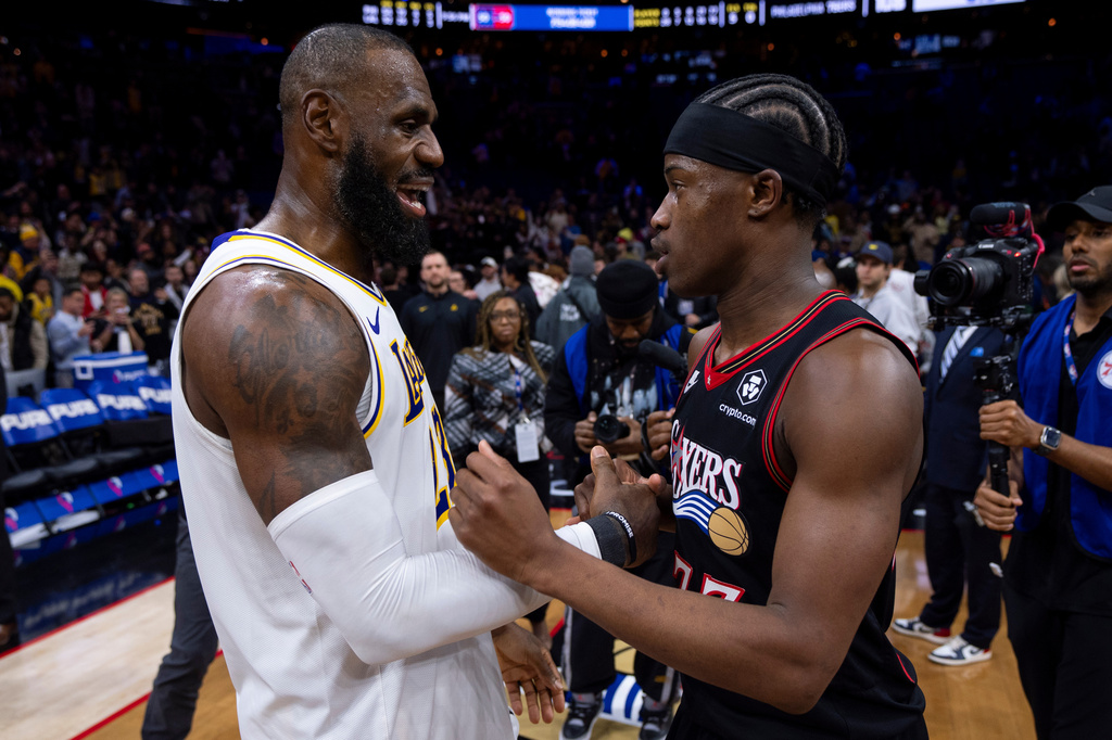 FILE - Los Angeles Lakers' LeBron James, left, talks with Philadelphia 76ers' VJ Edgecombe, right, following an NBA basketball game, Dec. 7, 2025, in Philadelphia. (AP Photo/Chris Szagola, File)