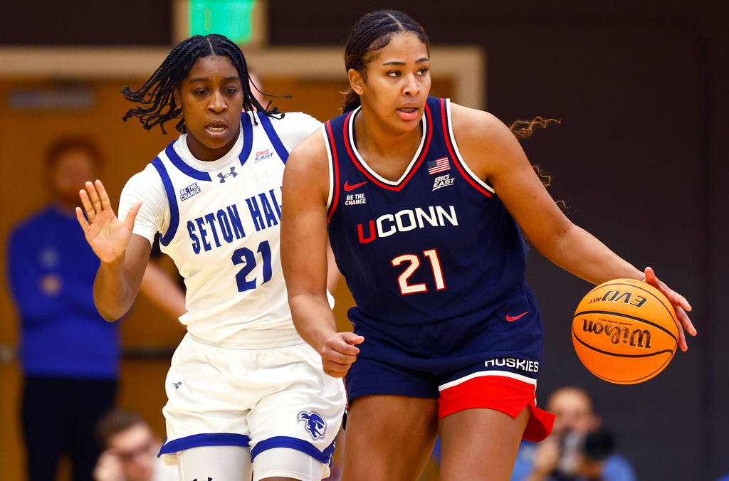 UConn forward Sarah Strong (21) dribbles the ball against Seton Hall forward Shailyn Pinkney (21) during the first half of an NCAA college basketball game, Saturday, Jan. 24, 2026, in South Orange, N.J. (AP Photo/Noah K. Murray)