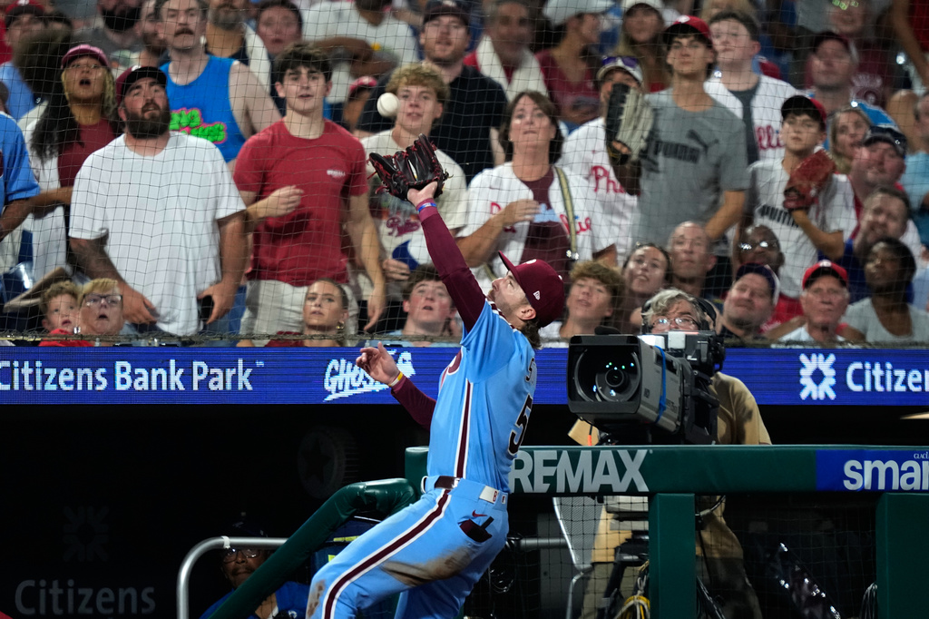 Philadelphia Phillies third baseman Bryson Stott catches a pop foul out by Washington Nationals' CJ Abrams during the seventh inning of a baseball game Thursday, Aug. 6, 2026, in Philadelphia. (AP Photo/Matt Slocum)