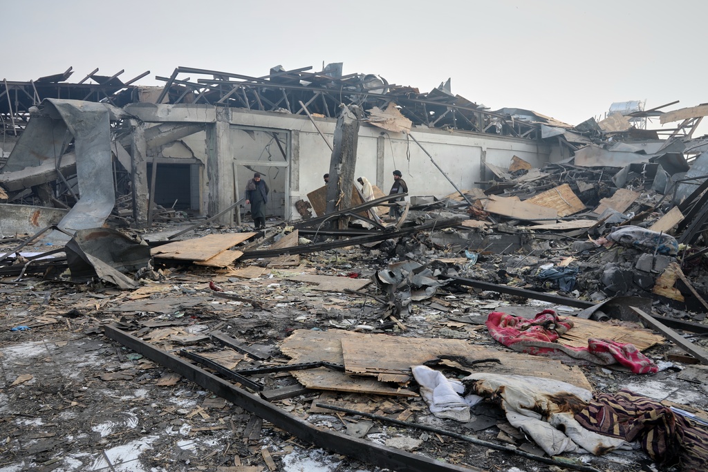 Residents and rescue workers inspect the site of a late-Monday airstrike at a drug rehabilitation hospital in Kabul, Afghanistan, Tuesday, March 17, 2026. (AP Photo/Siddiqullah Alizai)