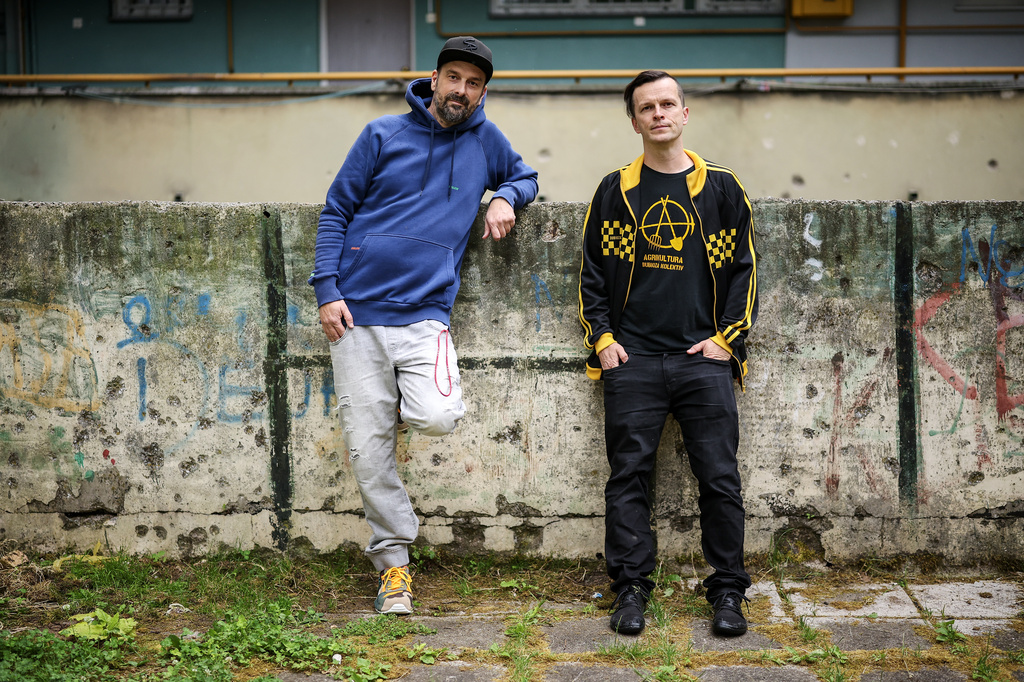 Brano Jakubovic, left, and Vedran Mujagic, members of Bosnian band Dubioza kolektiv, pose for a photo at a soccer playground where the video for the song "I Am From Bosnia, Take Me to America" was filmed, in Sarajevo, Bosnia, Thursday, June 11, 2026. (AP Photo/Armin Durgut)