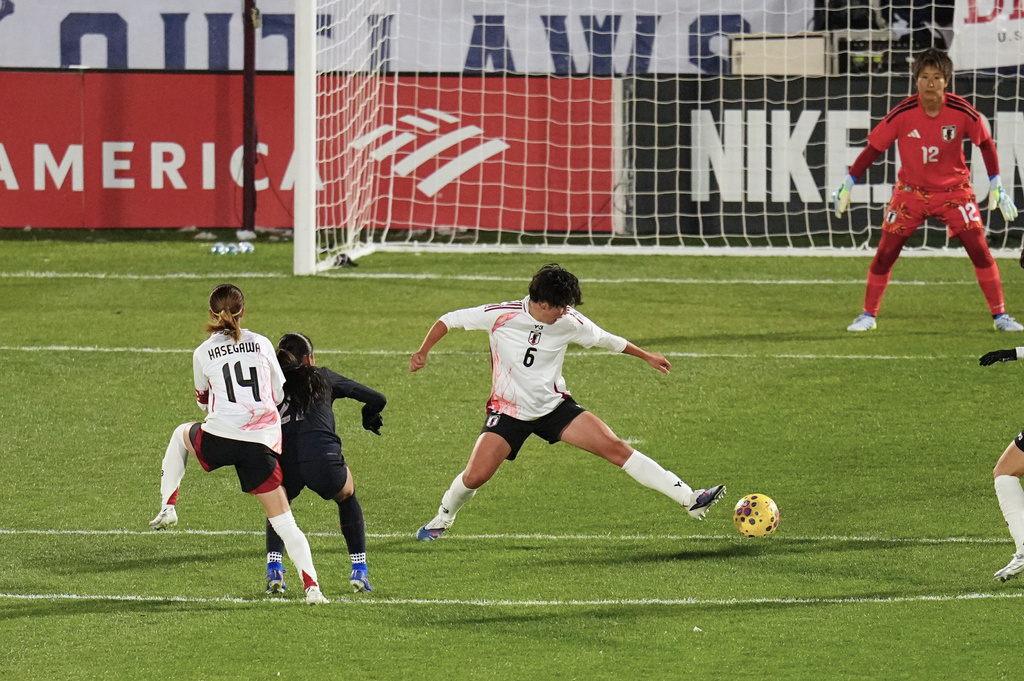 Japan defender Toko Koga (6) tries to block a shot by United States defender Gisele Thompson during the first half of an international friendly soccer match Friday, April 17, 2026, in Commerce City, Colo. (AP Photo/Jack Dempsey)