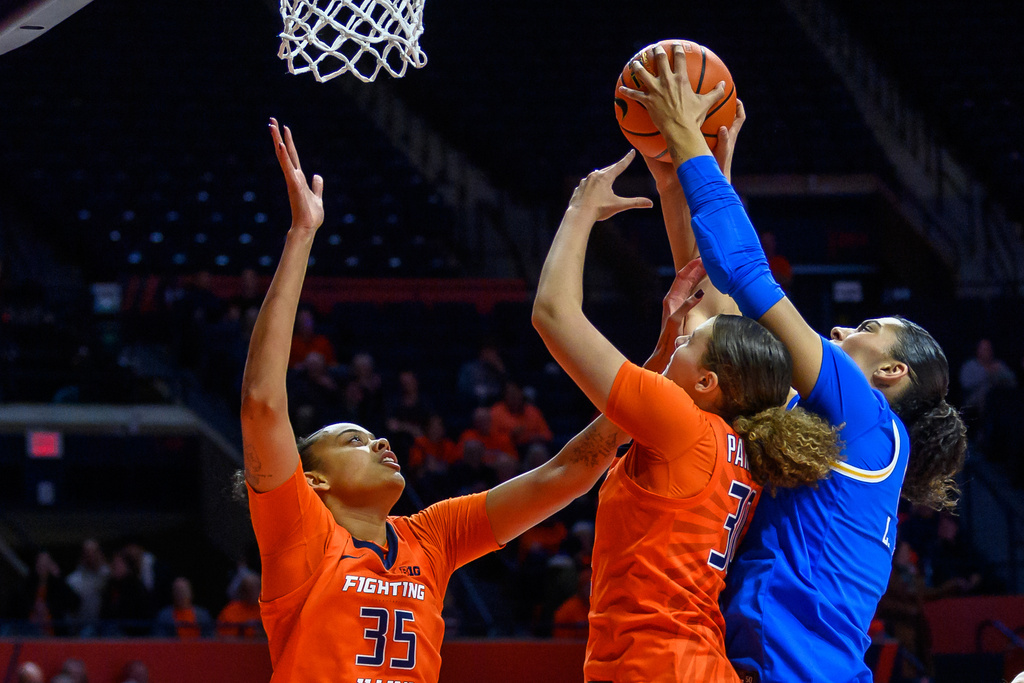 Illinois' Cearah Parchment and Lety Vasconcelos (35) battle for a rebound with UCLA's Lauren Betts during the first half of an NCAA college basketball game Wednesday, Jan. 28, 2026, in Champaign, Ill. (AP Photo/Craig Pessman)